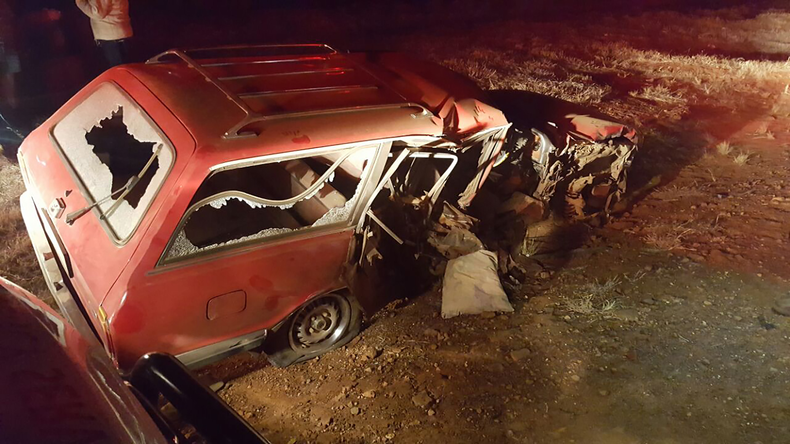 The station wagon on the side of the road after the collision