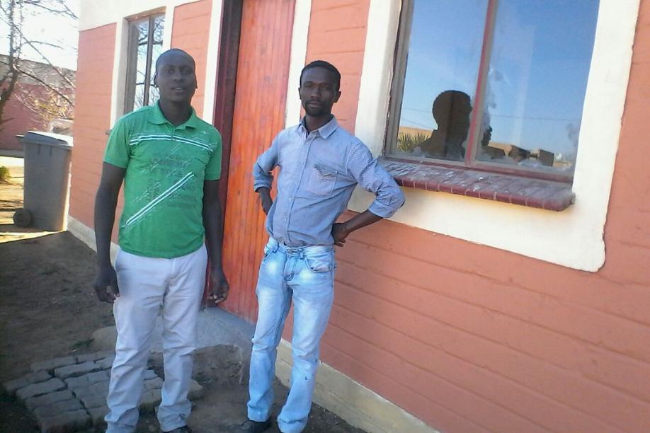 Tebogo Godfrey and Engnosi April standing in front of the house they have renovated after it got burnt down