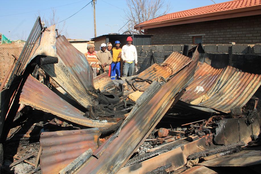 Community members at the burnt out shack.