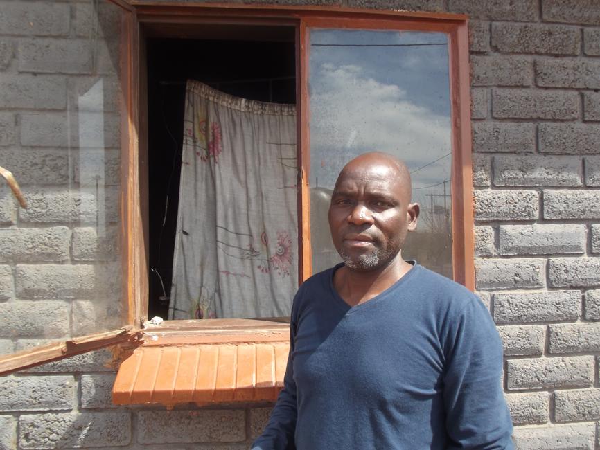 The heroe Mr Dickson Manukha standing by the window where he enetredto rescue the children