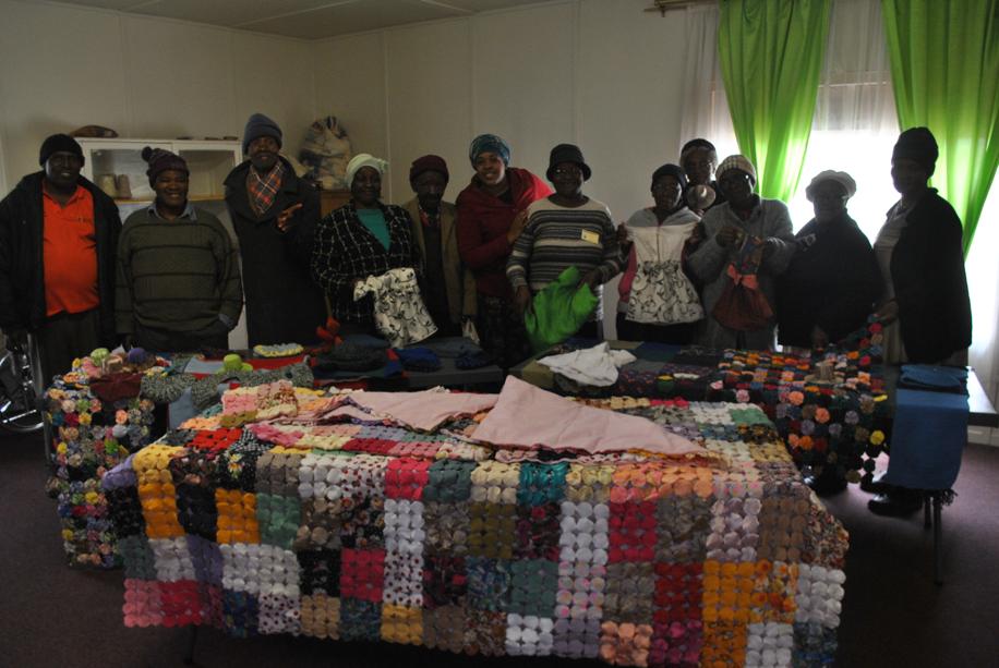 The elderly men and women at the centre stading infront of their designs