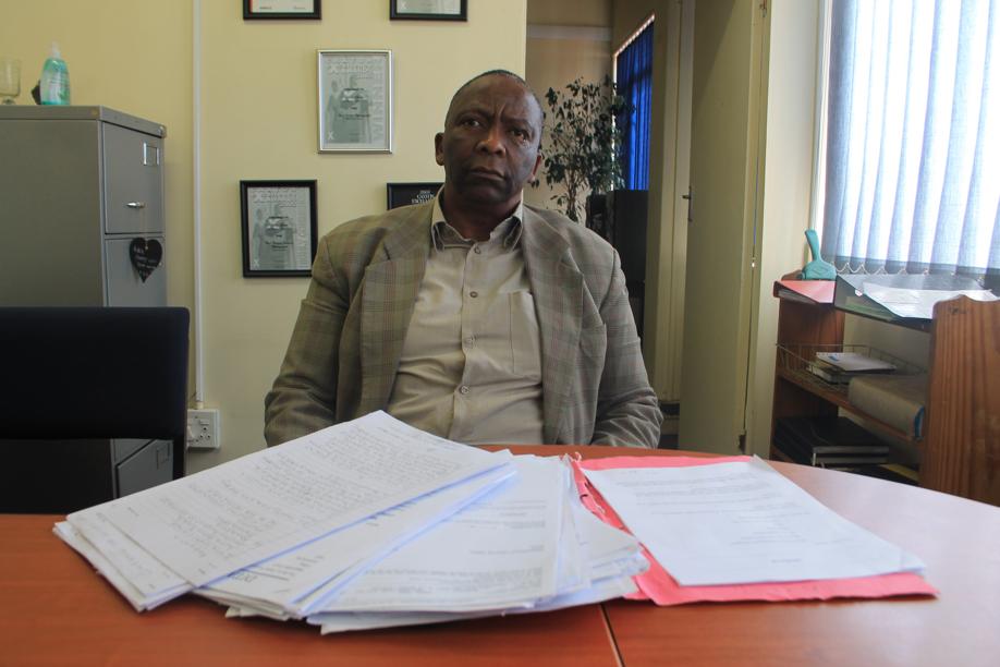 Mr Great Caesar Ngangamsha Bungane with some of the documents relating to his case.