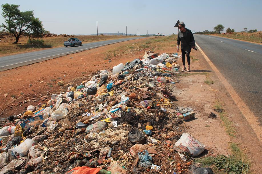 Ms Annett Venter with the rubbish dumped on the island next to the informal housing area.