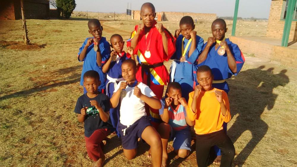 In the back row are Peter Selemela (gold), CJ Hlope (gold), Sam Sathikge (gold), Katlego Sathikge (silver) and Thabo Maringa (silver). In front are Papi Masemola, Bokamoso Dun jane (silver), Omolemo Sithole and Kagiso Selemela