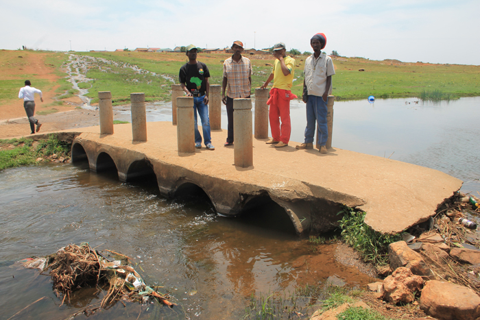 Another bridge over the Wonderfonteinspruit where sewage flows into the river polluted with mining waste.