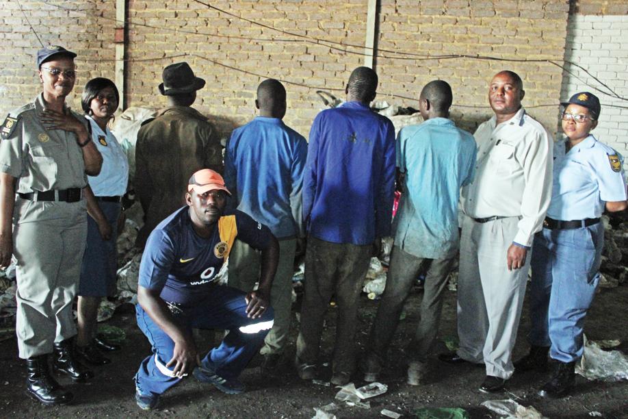 The police and Immigration Department after they arrested the illegal foreign nationals at a plastic factory shop near Boipatong.Photo: Lazarus Dithagiso