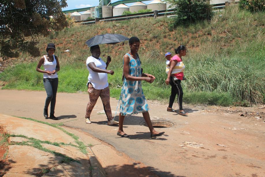 Residents walking past the open manhole in Ada Street.