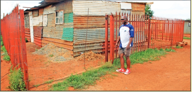 A community leader, Mr Vusi Mcunana, stands at shack that was built on the site where the prefabricated Ward 4 office was burnt down.