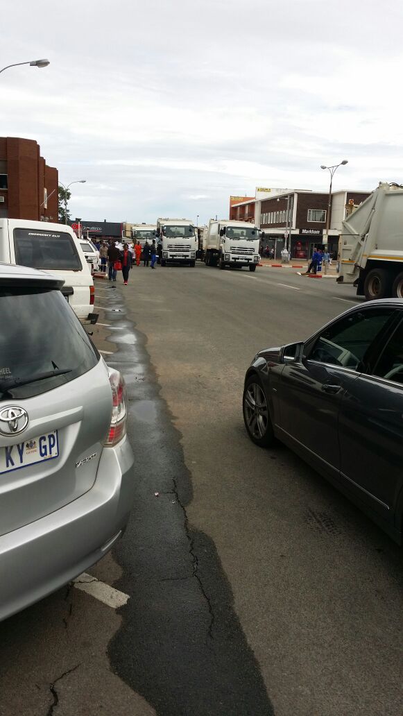 Refuse trucks blocking the road in front of the municipal office in Carletonville.