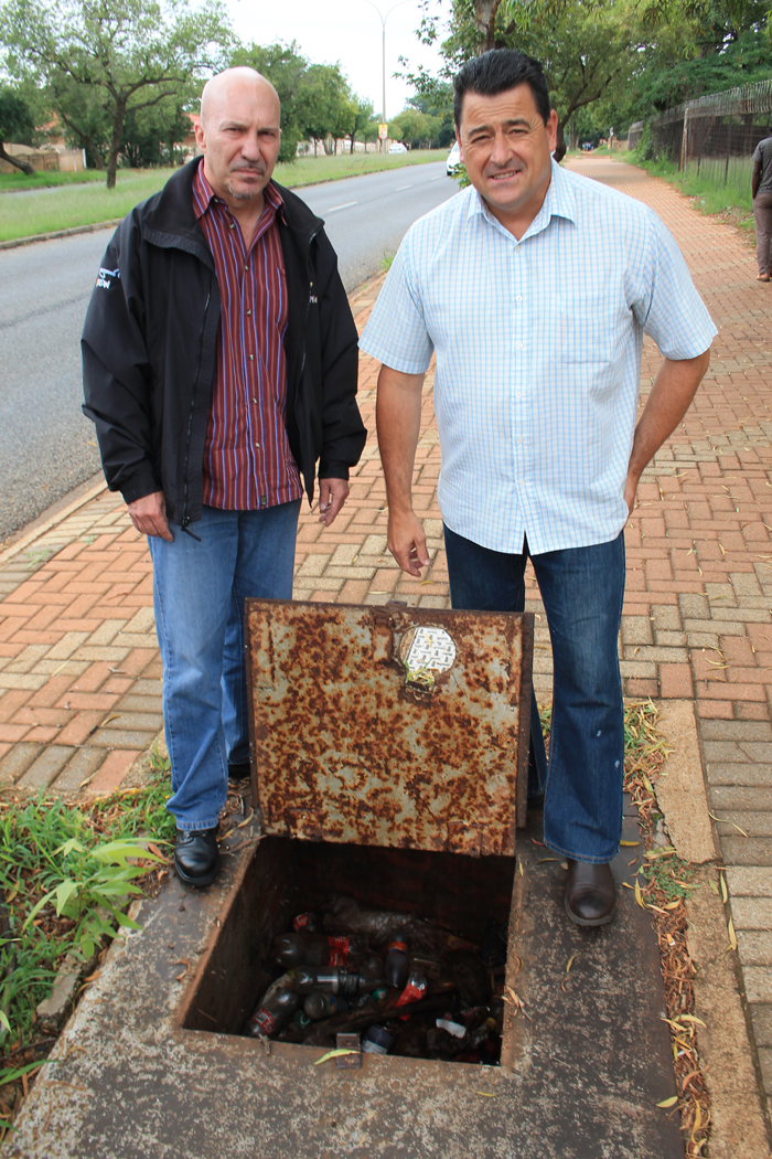 Messrs. Carlos Rebelo and Gary Isherwood at the PRV box filled with rubbish.