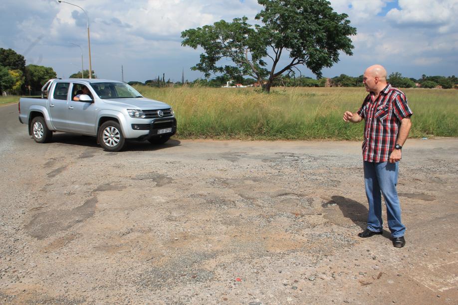 Mr Carlos Rebelo at some of the potholes in Wolmarans Street.