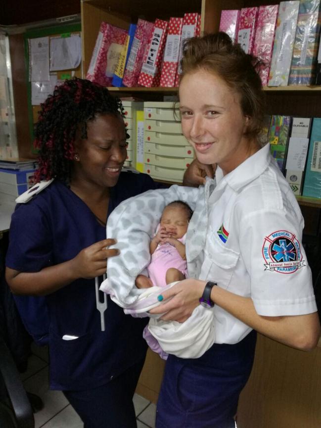 A nurse and paramedic holding the abondened child