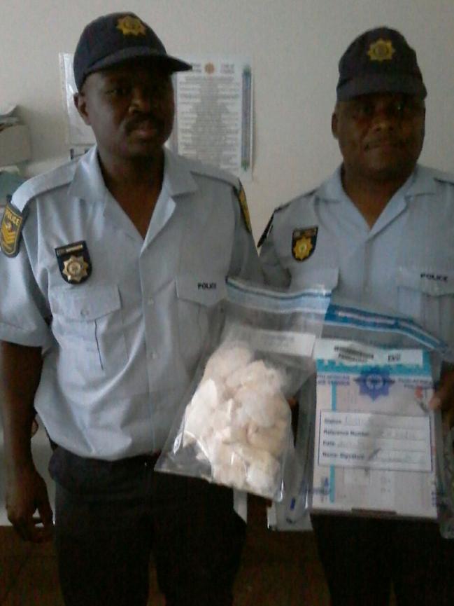 police officers holding drugs that were found