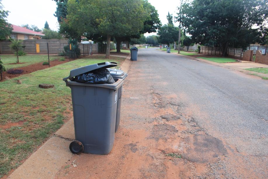 Full rubbish bins that were not emptied by the municipality lining Kriek Street in Carletonville Extension 9 on 27 February.