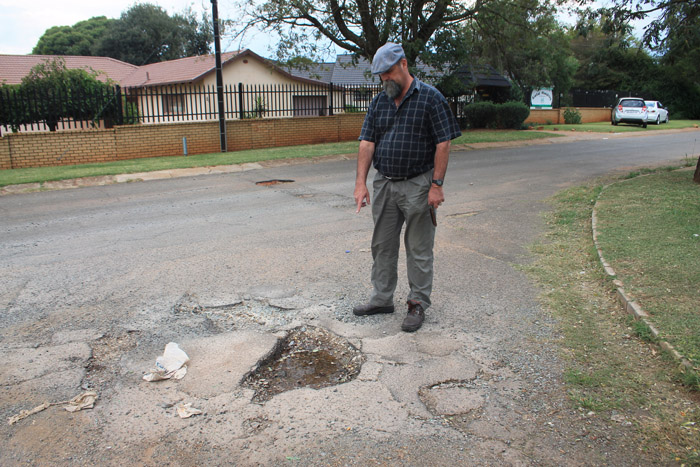 at one of the dangerous potholes at the intersection.