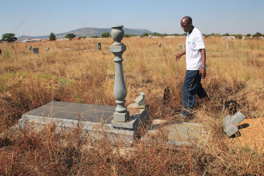 Mr Macist Ndubatha at one of the damaged gravestones.