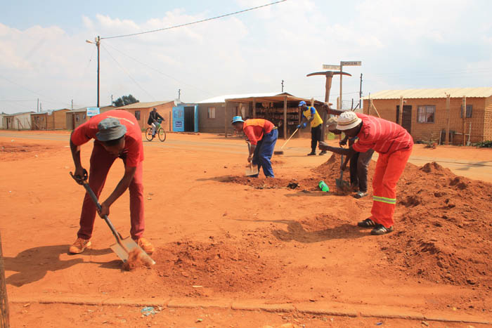 Some of the former drug users working to clean a street in Ext. 4.