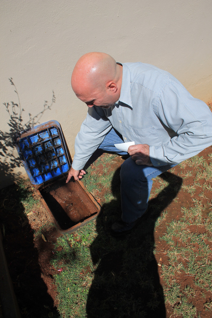 Mr Carlos Rebelo at the leaking water meter in Kriek Street.