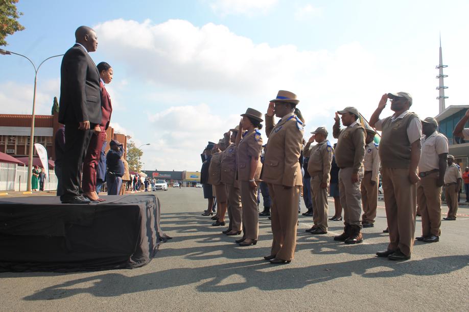 The Mayor, Speaker and Chief Whip with saluting traffic officers and police during the singing of the National Anthem.