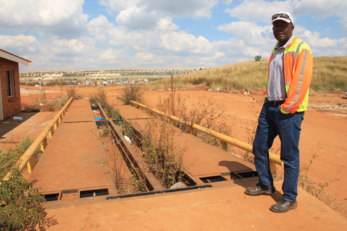 The contractor currently working at the problematic Rooipoort landfill site, Mr Alex Nkoenyae, at the vandalised weighbridge at the facility.