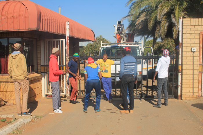 The protesters block a gate at the traffic department.