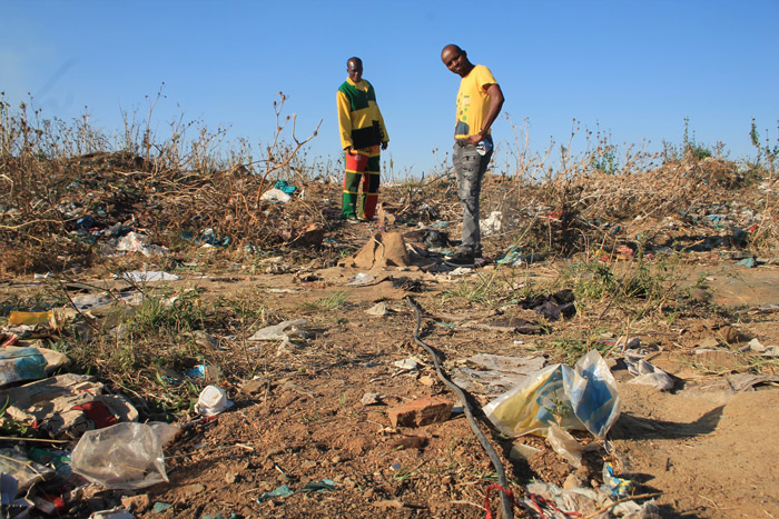 Messrs. Mosiwa Moalusi and Macist Ndubatha under some of the illegal connection wires.