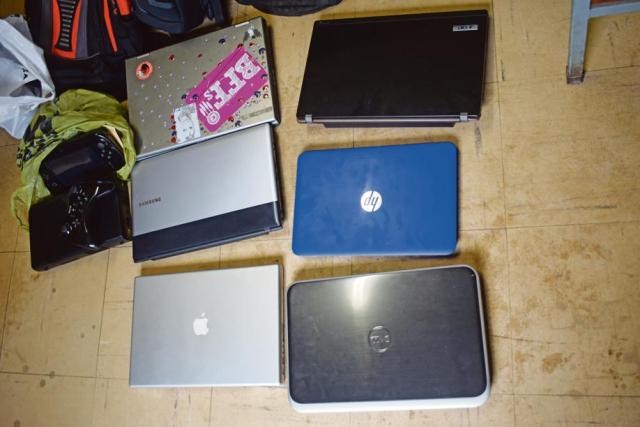 The six laptops and a PlayStation that the police recovered with the help of the community. Photo: Selogile Leshage