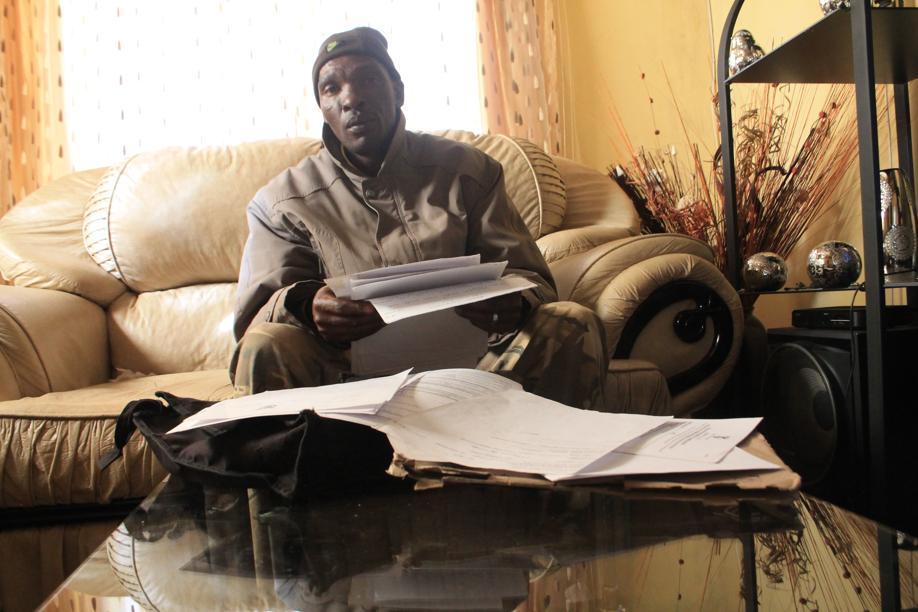 Mr Mninezeli Linda Lombo with some of the many documents proving his innocence.