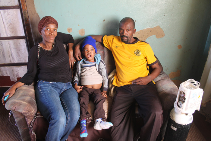 Mrs Agnes Setlaboshane and her husband, Tumelo, with their disabled son, Neo.