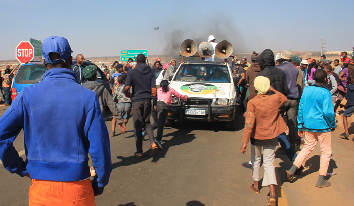 Upset residents, some of them children, storming an ANC bakkie during last week's protests.