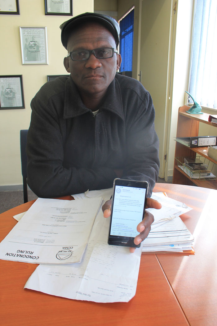 Mr Daniel Tsietsi Lekgetho has some of the documents regarding his case andshowing correspondence between him and the NUM's general secretary, Mr David Sipunzi, on his phone.