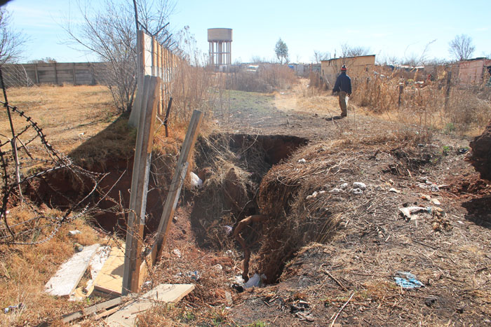 The sinkhole that has still not been repaired.