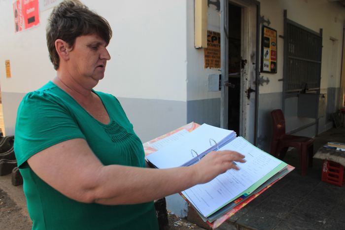 Ms Jeanette Pearce with a file of documents, which includes various proof of payments to the municipality for water.