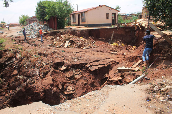 Some fearless residents take a short cut across the dangerous sinkhole.