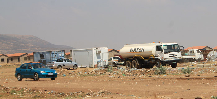A tanker truck delivering water to some of the contractors at the Ext. 6 housing project.