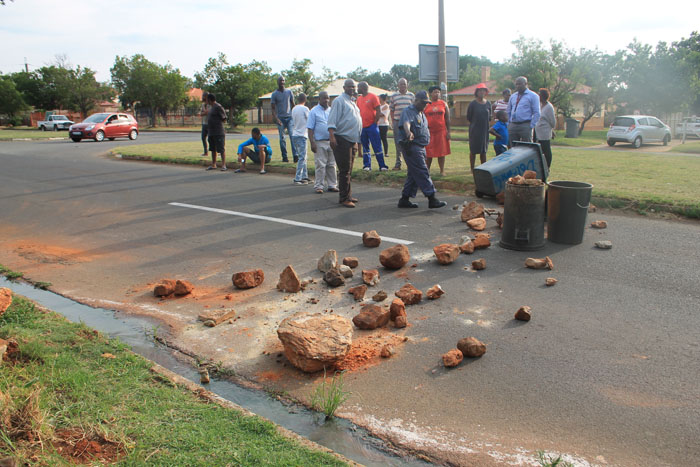 Col Abel Gasa negotiates with the furious residents who blocked a part of Dolomite Road late on Tuesday afternoon.