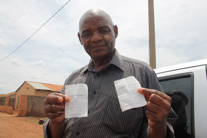 Mr Alfred Leo Leroala with the two electricity purchasing slips that made him wonder. Adele