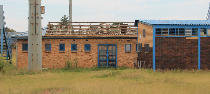 The corrugated iron roofing on one of the buildings has almost been stripped completely