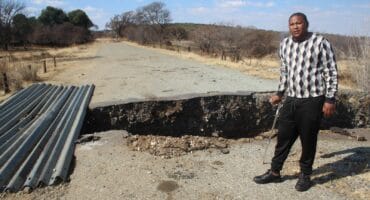 Mpumemelo Gaba, who was also injured in the accident, at the open culvert in which his bakkie plunged on Friday night.