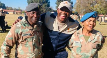 The student in the middle at the military base with fellow officers