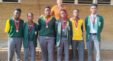 Hoërskool Carletonville’s U19 chess team and their proud coach.
