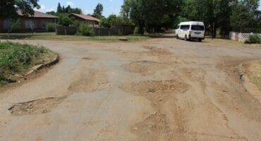There are several deep potholes all over the intersection of Bosman and Du Preez Streets.