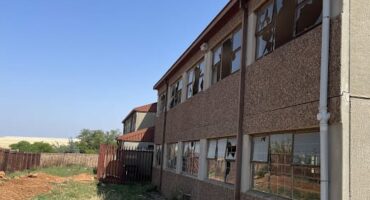 Broken windows at the back of the school.