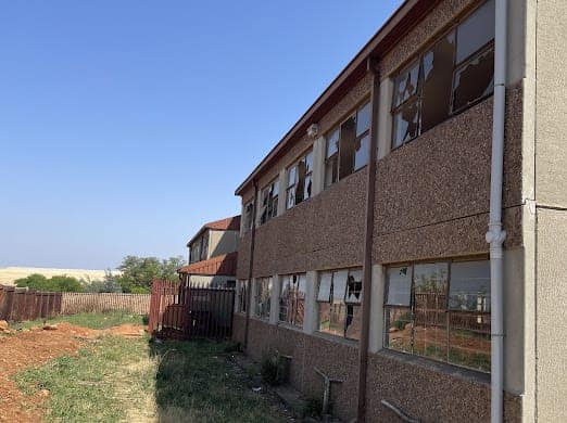Broken windows at the back of the school.