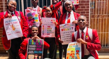Some of the proud CJ learners with their posters.