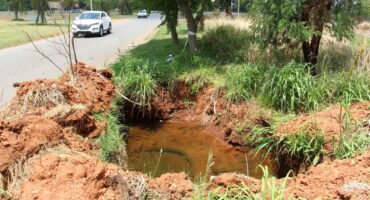 The big water-filled hole on the side of Dolomite Drive.