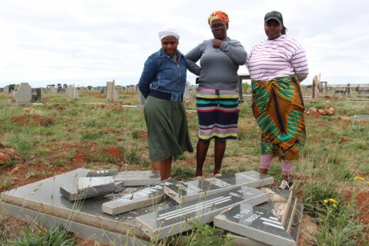 Keamogetsi Mogotsi, Betty Mogotsi and Lizzy Kamele at the smashed gravestone of their late sister, Motshidisi Kamele.