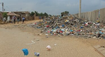 Papers blowing from the huge dump.