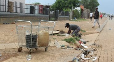 Despite the fact that there was a big storm approaching, this desperate Kokosi resident was busy taking water from a manhole on the sidewalk across from Extension 99 on November 6. Many residents have been forced to use water from unsafe places such as manholes due to the severity of the water problems in this area. Photo: Adele Louw