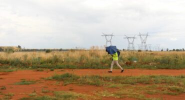 A pedestrian walks past the veld at the back of Khutsong Extension 5, where the husband was kept hostage.